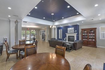 A large room with a fireplace and a bookcase.
